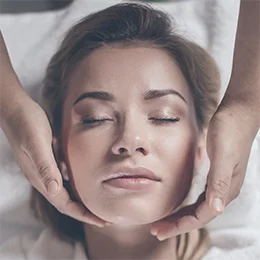  Woman receiving a facial massage.