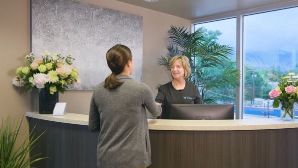 The friendly front desk staff at The Facial Center ready to welcome new patients.