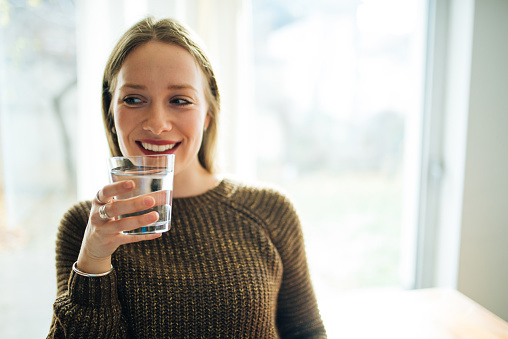 A woman drinking a glass of water