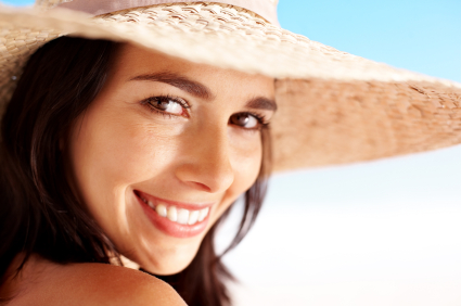 A woman woman with a large hat smiles The Facial Center in Charleston, WV