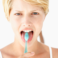 A woman brushing her toungue The Facial Center in Charleston, WV